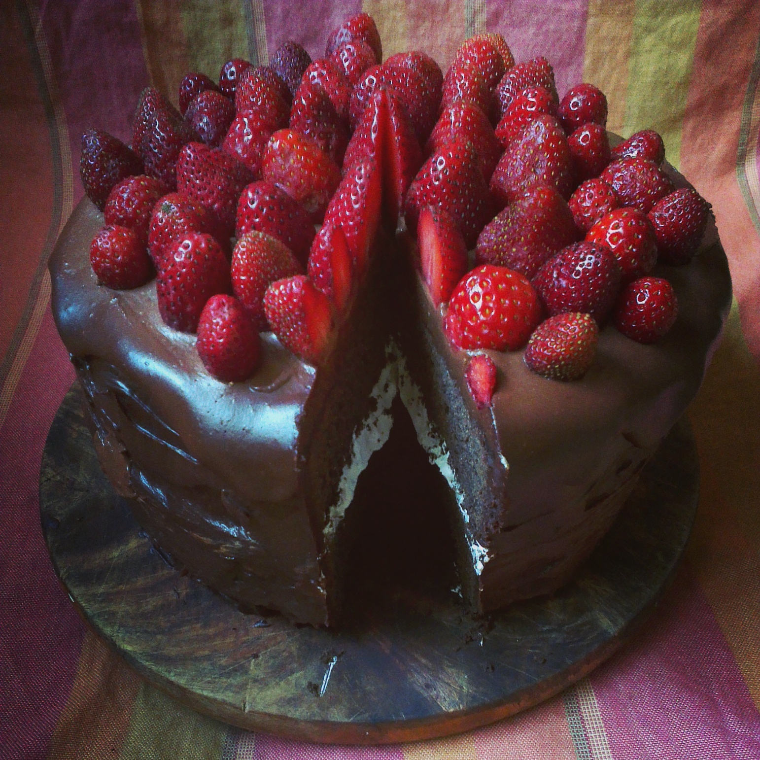Dark chocolate and strawberry celebration cake, with a nougat layer in the middle